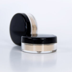 loose mineral face powder in cylindrical clear container with black lid