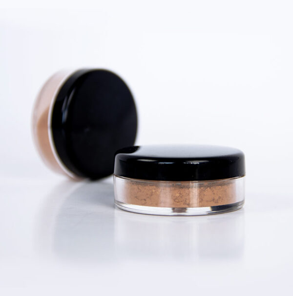 loose mineral blush in cylindrical container with black lid