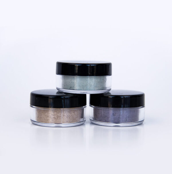 3 cylindrical containers with loose mineral eyeshadow inside closed with black lid