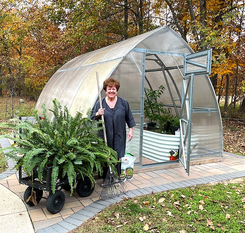 cindas-botanical-blends-cinda-standing-in-front-of-greenhouse